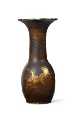 a black vase with a gold design on it
