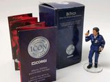 a figurine of a man holding a gun next to a box of books
