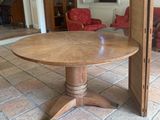 a wooden table with two chairs in a living room