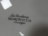 the bottom of a white plate with black writing on it