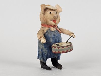 a small figurine of a pig with a drum