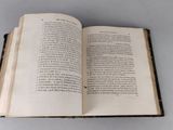 an open book on a table with a white background