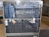 a metal cage with a bunch of luggage in it