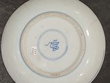 a white plate with a blue and white design on it