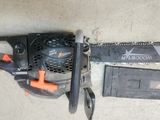 a chainsaw and a tool that is laying on the ground