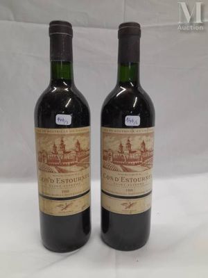 two bottles of wine sitting next to each other on a table