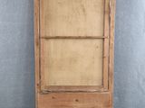 an old wooden cabinet with a glass door on top of it