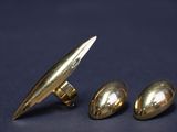 two pairs of gold cufflinks and a pair of silver cufflinks