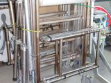 a metal cart with a bunch of pipes attached to it