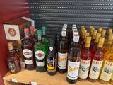 many bottles of alcohol on a shelf in a store