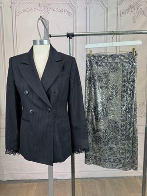 a suit and a skirt on a stand in a room