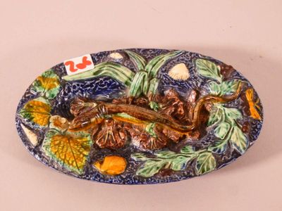 a decorative plate with a fish and vegetables on it