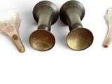 three cups and spoons that are sitting on a table