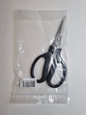 a pair of scissors sitting in a bag on a table