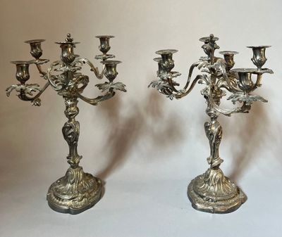 pair of antique silver plated candelabs with angels on them