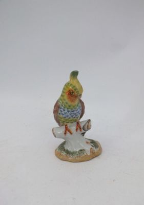 une figurine représentant un oiseau perché sur une souche d'arbre