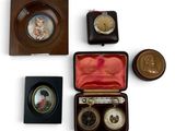 four different types of clocks in a case on a white surface