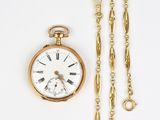 gold plated pocket watch and chain on a white background