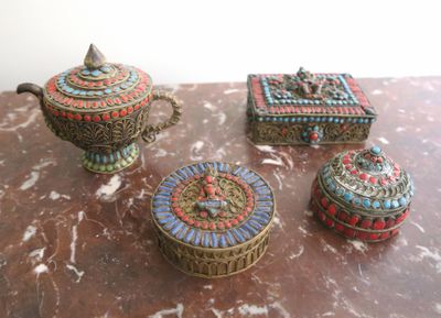 three decorative boxes sitting on top of a table next to each other