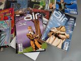 a lot of comic books sitting on a table