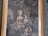 an old picture of a woman and child sitting in a chair