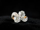 a pair of diamond earrings on a black background