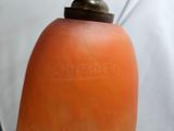 an orange plastic bottle with a metal cap on it