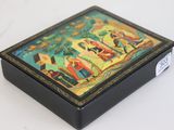 a small box with a painting on it on a table