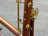 a wooden frame with brass hardware on it on the street