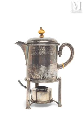a silver tea pot sitting on top of a stove