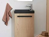 a bathroom with a sink, mirror and a towel rack