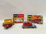 several toy vehicles are lined up on a white surface