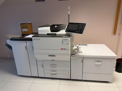a printer sitting on top of a desk in a room