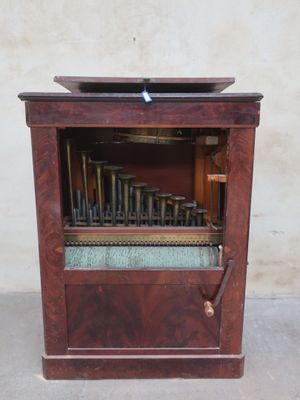 a wooden cabinet with a musical instrument inside of it