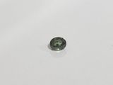 a green tourmaline gemstone on a white surface