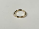 a close up of a gold ring on a white surface
