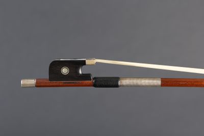 a close up of a violin bow with a wooden handle