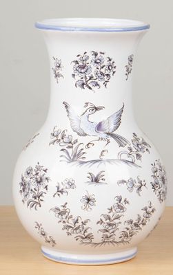 a white vase with a blue and white design on it