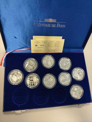 a blue box with six silver coins in it