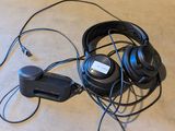 a pair of headphones and a charger on the floor