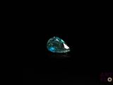 a close up of a blue diamond on a black surface