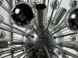 a close up view of a chandelier made of chrome balls