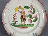 une image représentant une assiette décorative sur laquelle figure un oiseau