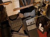 a pile of assorted items in a room with a red carpet