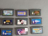 a lot of nintendo game cartridges sitting on a table