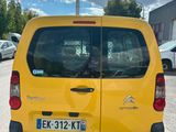 a small yellow van parked in a parking lot