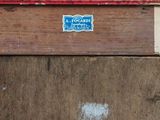 a sign on the side of a wooden building