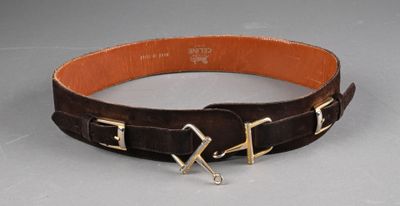 brown leather belt with two metal buckles on a gray surface