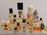 many different types of perfumes on display in a glass case