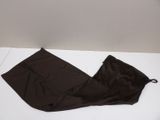 brown pants laying on a white surface with a white wall in the background